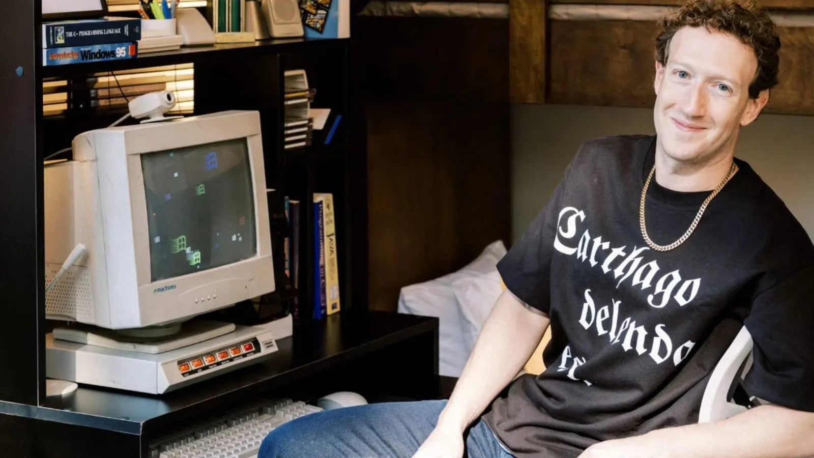 Tech billionaire sitting in front of a vintage computer with a bookshelf in the background and a Roman Empire clothing